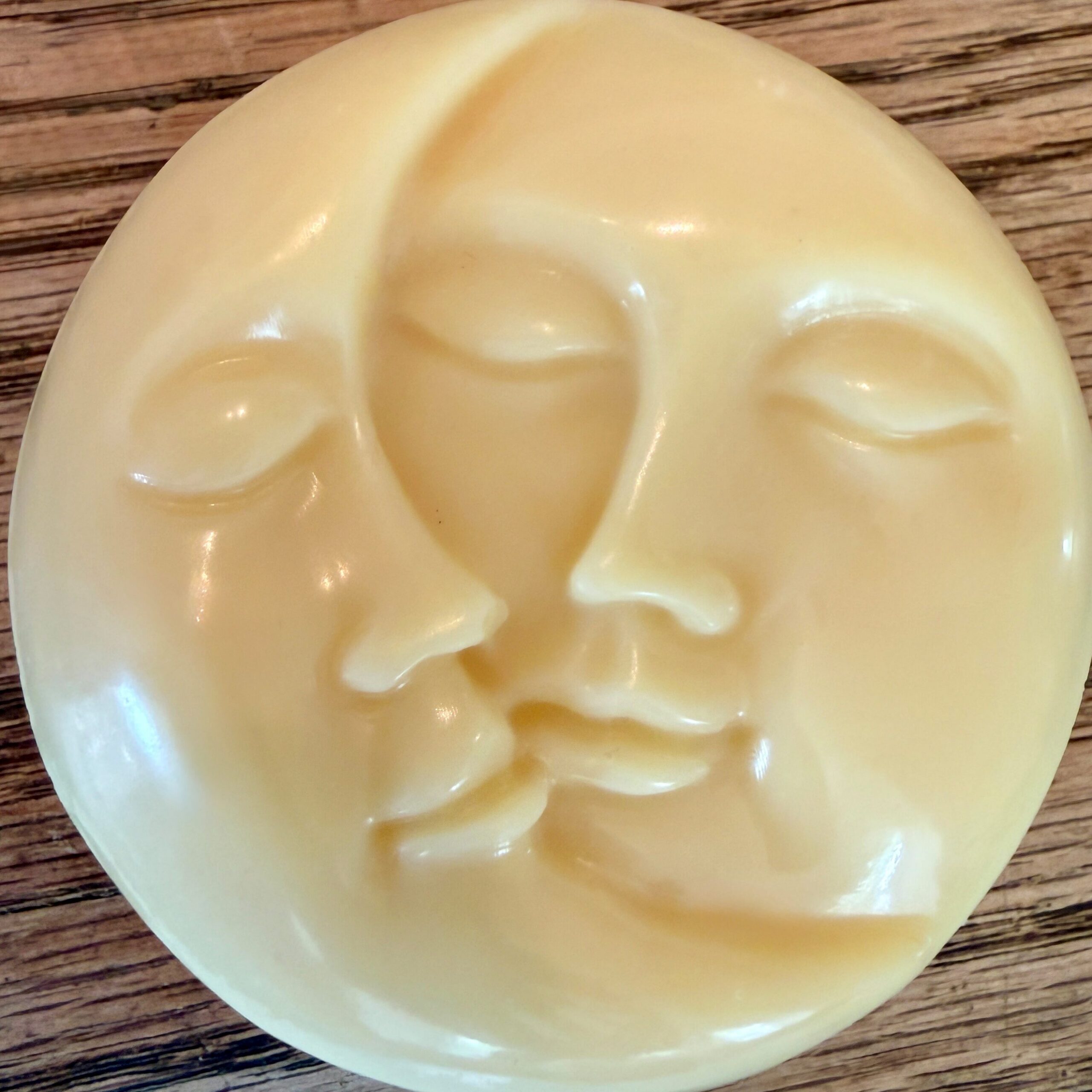 body balm molded into a sun and moon shape