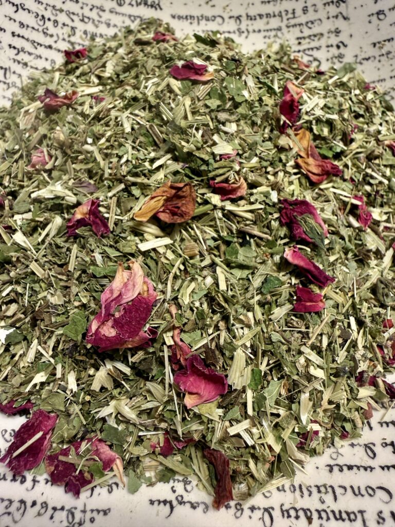 dried loose tea with a variety of green leaves and rose petals